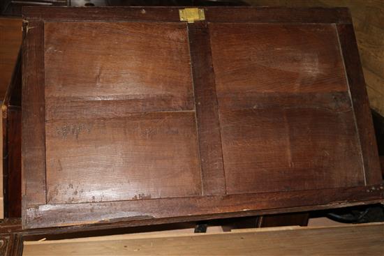 A 17th century oak carved and panelled two door hanging cupboard, W.150cm (a.f.)